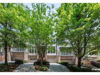 Stunning townhomes boasting manicured lawns, driveways and staircases leading to covered balconies, complemented by mature landscaping at 1308 Fernwood Ne Cir, Atlanta, GA 30319