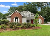 Charming single-Gathering home with brick accents, well-maintained landscaping, and a welcoming front porch at 2881 Bridle Creek Sw Dr, Conyers, GA 30094