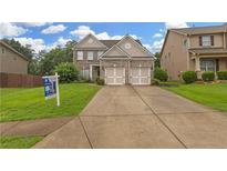 Charming two-story home featuring a brick facade, two-car garage, and well-maintained lawn at 405 Highbranch Cir, Lawrenceville, GA 30044