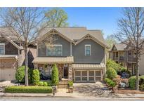 Charming home with stone accents, a well-manicured lawn, and an attached two car garage at 4541 Gateway Se Ct, Smyrna, GA 30080
