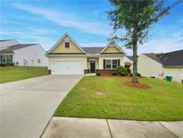 Charming home featuring a well-maintained lawn, a two-car garage, and inviting curb appeal at 6100 Semaphore Rdg, Rex, GA 30273