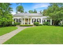 Elegant white home featuring a large lawn, columns, and classic shutters at 2 W Muscogee Nw Ave, Atlanta, GA 30305
