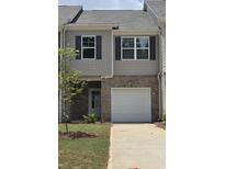 Charming two-story townhouse with a brick facade, attached garage and well-maintained lawn at 2804 Lillian Ln, Douglasville, GA 30135