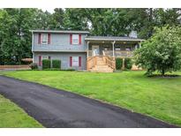 Charming two-story home featuring a spacious front yard, inviting porch, and well-maintained landscaping at 123 Mill Ln, Dallas, GA 30157