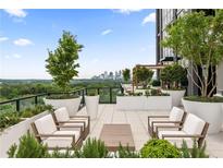 Inviting rooftop terrace with ample seating, lush greenery, and skyline views for relaxing or entertaining guests at 2425 Peachtree Ne Rd # 1503, Atlanta, GA 30305