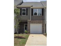 Two story townhome with brick facade and attached one car garage at 2812 Lillian Ln, Douglasville, GA 30135