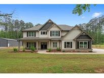 Charming two-story home with a beautifully landscaped yard and a welcoming front porch at 337 Paynes Lake Rd, Carrollton, GA 30116