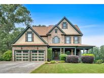 Charming two-story home with a two-car garage, stone accents, and a welcoming front porch at 17 River Walk Pkwy, Euharlee, GA 30145