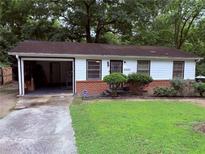 Charming one-story home with a brick foundation and an open, attached carport at 2800 Browntown Nw Rd, Atlanta, GA 30318
