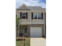 Charming two-story townhome featuring a brick-accented garage and neutral siding at 2808 Lillian Ln, Douglasville, GA 30135
