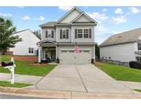 Charming two-story home with manicured lawn, covered entryway, and neutral gray tones at 106 Cessna Dr, Canton, GA 30114