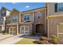 Charming brick townhome with attached garage and covered entryway at 100 Trailside Way, Hiram, GA 30141