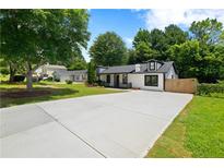 Charming home with a new concrete driveway, and a lush green lawn, perfect for families at 4946 Lake Ridge Trail, Lilburn, GA 30047
