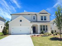 Charming two-story home with a brick and siding exterior, manicured lawn, and a two car garage at 62 Sheryl Way, Loganville, GA 30052