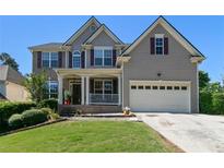 Charming two-story home featuring a well-maintained lawn, two-car garage, and inviting front porch at 829 Castlebottom Dr, Lawrenceville, GA 30045