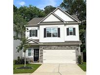 Charming two-story home features white siding, stone accents, a two-car garage, and a manicured lawn at 158 Bryon Ln, Acworth, GA 30102