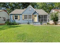 Charming blue home featuring a screened porch and a well-maintained front lawn at 1649 Beecher Sw St, Atlanta, GA 30310