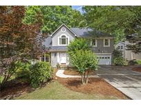 Charming two-story home with a well-manicured lawn and a cozy, inviting curb appeal at 1867 N Creek Cir, Alpharetta, GA 30009