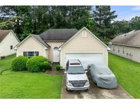 Inviting single-Gathering home with a well-maintained lawn and a two-car garage at 1394 Isleworth Cir, Atlanta, GA 30349