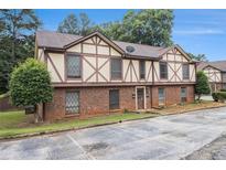Charming townhome with Tudor-style architecture and well-maintained brick facade at 3232 Abbeywood Dr, Decatur, GA 30034