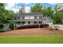 Charming two-story home with a welcoming front porch and meticulously landscaped front yard at 4920 Hampton Lake Dr, Marietta, GA 30068