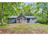 Charming single story home featuring a stone chimney and situated on a tree-lined lot at 4985 Watkins Ct, Winston, GA 30187