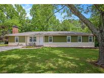 Charming home with a well-manicured front yard and an inviting stone facade at 3852 Drew Campground Rd, Cumming, GA 30040