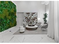 Bright lobby area with modern furniture, a living wall, and white marble floors at 775 Juniper Ne St # 210, Atlanta, GA 30308