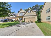 Charming two-story home with a brick front, inviting entrance, and a two car garage at 2550 Trelipe Dr, Lawrenceville, GA 30044