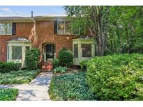 Charming brick townhouse with well-maintained landscaping and bay windows at 1386 Sheffield Glen Ne Way, Atlanta, GA 30329