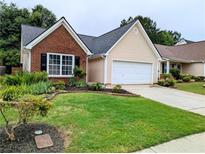 Charming single-Gathering home with brick and siding and a well-manicured front yard at 225 Kentshire Pl, Lawrenceville, GA 30044