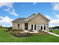 Charming brick home featuring manicured landscaping, a covered porch, and a welcoming entrance at 861 Pineberry Ct, Grayson, GA 30017