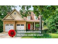 Charming two-story home featuring a combination of stone and siding, complemented by a bright red front door at 36 Laurel Ne Way, White, GA 30184