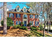 Beautiful brick home with manicured landscaping and charming blue shutters at 4506 Westcliff Ne Trce, Roswell, GA 30075