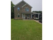 Inviting two-story home features a brick and stone facade, covered porch, and well-maintained lawn at 226 Woodwind Way, Jonesboro, GA 30238