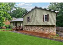 Charming home featuring a stone foundation and inviting front porch entrance at 251 Sabrina Ct, Woodstock, GA 30188