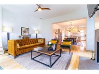 Inviting living room featuring hardwood floors, a stylish velvet sofa, and an open layout to the kitchen at 2067 Telfair Circle # A&B, Atlanta, GA 30324