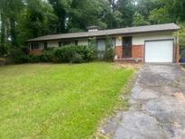 Cozy single-story home featuring a well-maintained front lawn and attached one car garage at 3729 Wisteria Sw Ln, Atlanta, GA 30331