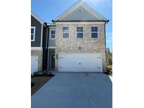 New construction home showcasing a two-car garage and light brick facade with complementary gray trim and matching roof at 5649 Hislop Ln # 90, Mableton, GA 30126