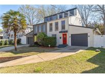 Modern two-story home with colorful doors, brick facade, garage, and well-manicured lawn at 549 Ne Parkway Ne Dr, Atlanta, GA 30308