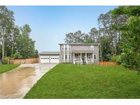 Charming two-story home with a well-manicured front yard and attached two-car garage at 1752 Shadybrook Ct, Lawrenceville, GA 30043