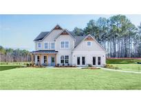 Beautiful two-story home with a large, well-manicured lawn and appealing architectural details at 272 Rockledge Sw Bnd, Powder Springs, GA 30127