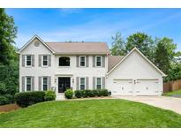Charming white two-story home with a well-manicured lawn and a two-car garage at 3710 Robinson Walk Ct, Marietta, GA 30068
