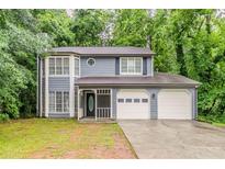Charming two-story home featuring a two-car garage and inviting front porch at 5352 Windfern Ct, Stone Mountain, GA 30088