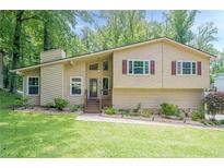 Charming home featuring a well-manicured lawn, neutral siding, and updated windows at 1137 Poplar Log Pl, Austell, GA 30168
