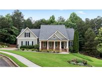 Charming home with stone accents, a well-manicured lawn, and lush landscaping provides great curb appeal at 12 Isabella Ne Ct, Cartersville, GA 30121