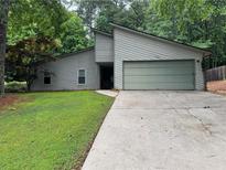 Charming single-Gathering home featuring a large garage, driveway, and well-maintained lawn at 2000 Kristian Way, Roswell, GA 30076