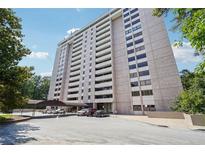 Modern high-rise condo building with covered parking and mature landscaping at 3530 Piedmont Ne Rd # 2I, Atlanta, GA 30305