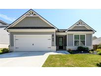 Charming single-Gathering home showcasing a gray facade, two-car garage, and well-manicured lawn at 2856 Knob Creek Dr, Snellville, GA 30078