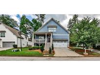 Charming two-story blue home with a welcoming front porch and manicured landscaping at 2956 Silver Hill Se Ter, Atlanta, GA 30316